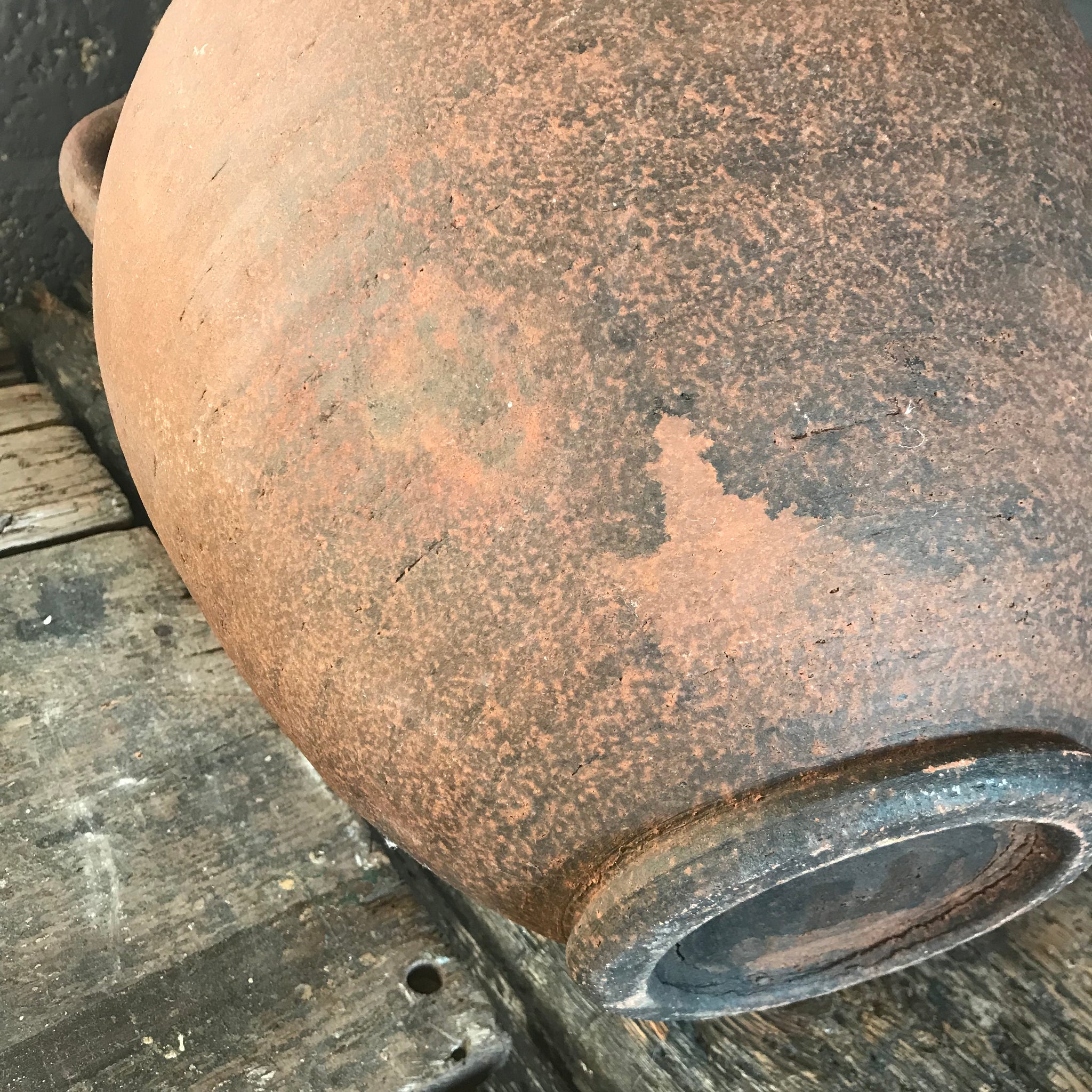 A pair of large terracotta urns with double lug handles