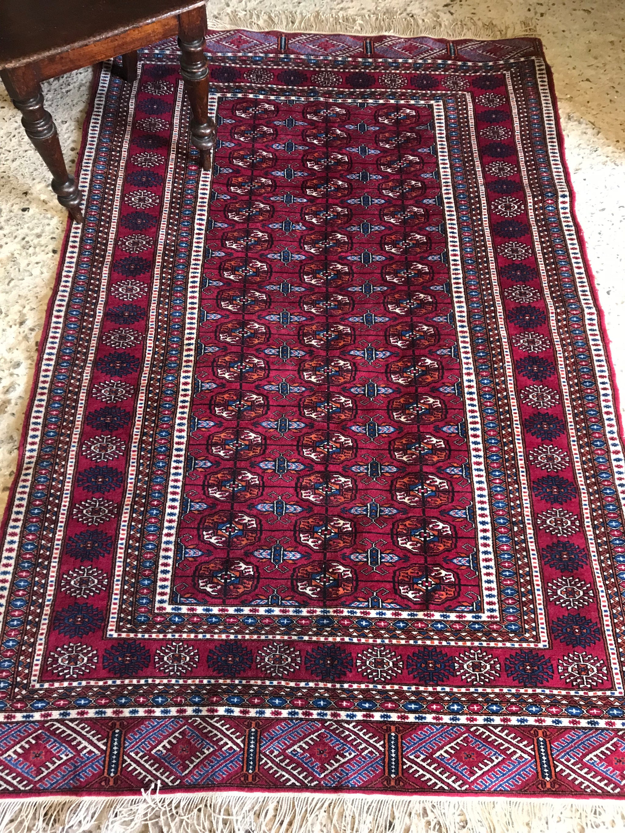 A rectangular red ground Persian rug