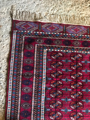 A rectangular red ground Persian rug