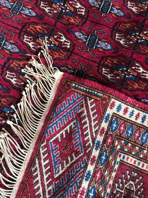 A rectangular red ground Persian rug