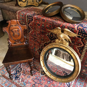 A Regency gilt convex ball and chain eagle mirror