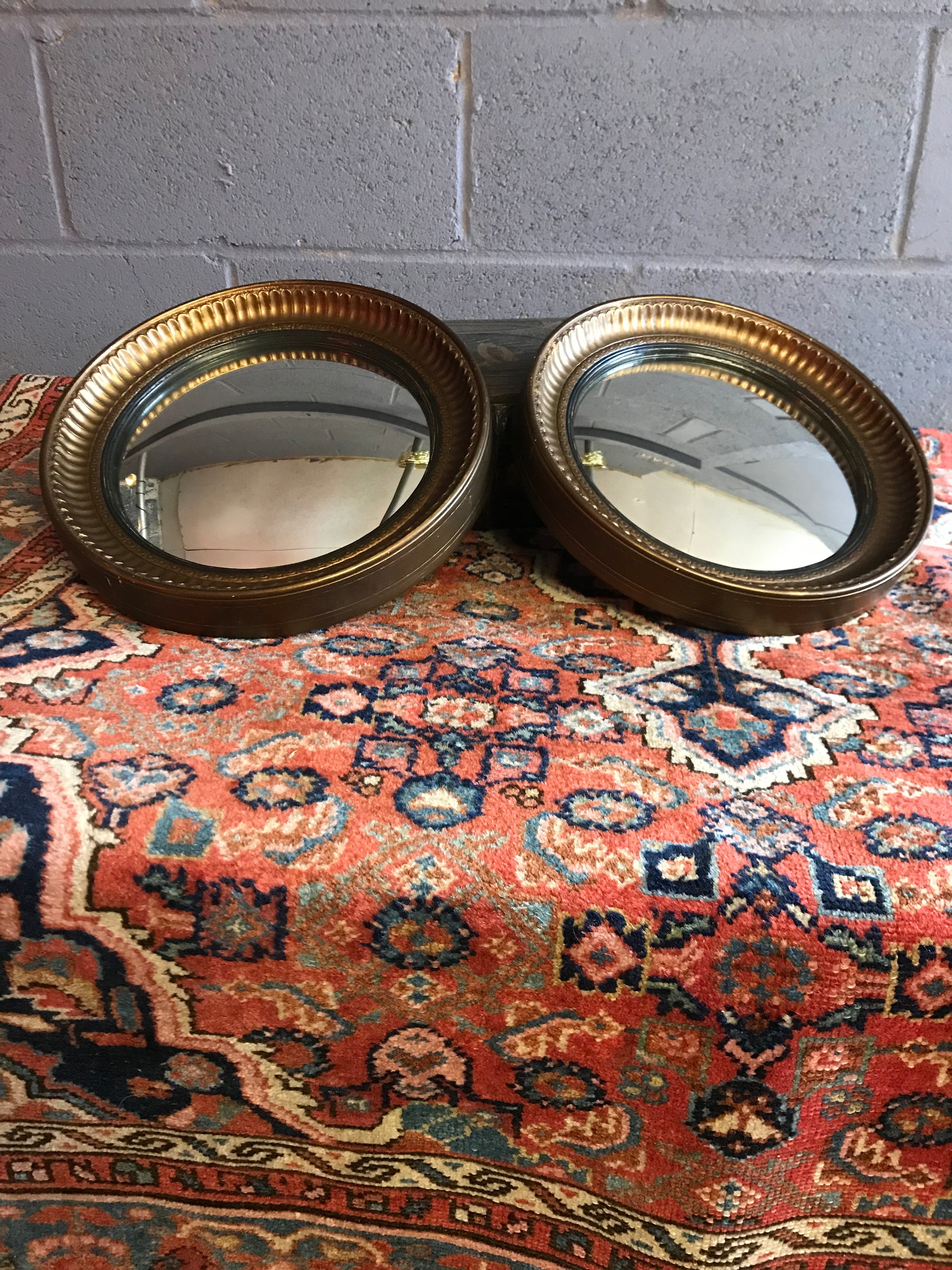 A rare pair of gilt convex ball mirrors