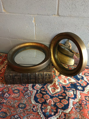 A rare pair of gilt convex ball mirrors