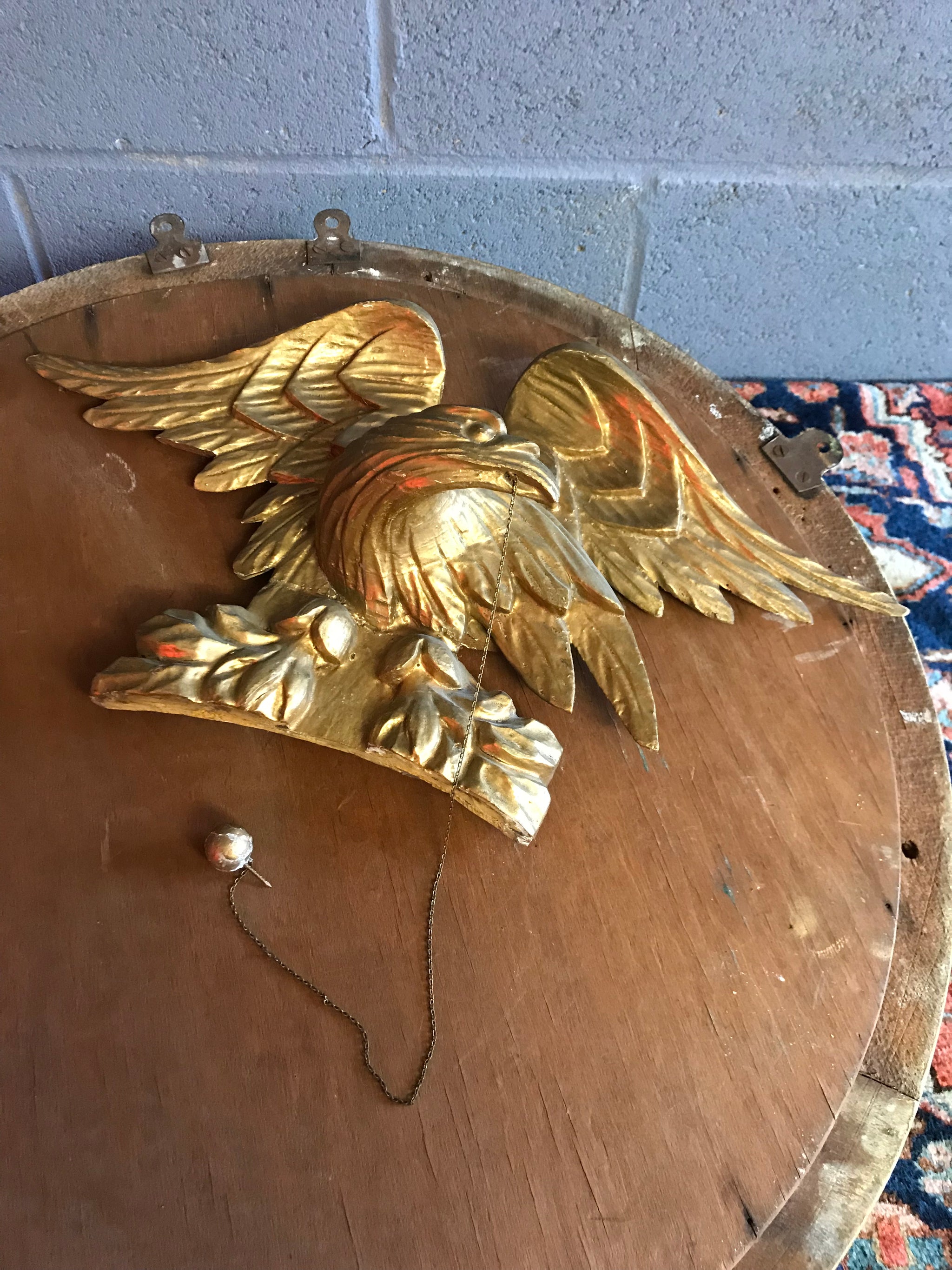 A Regency gilt convex ball and chain eagle mirror