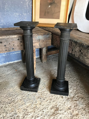 A pair of black wooden pedestal column display stands