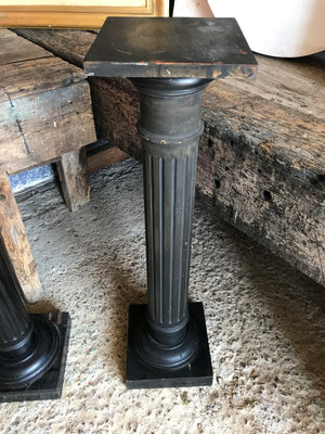 A pair of black wooden pedestal column display stands