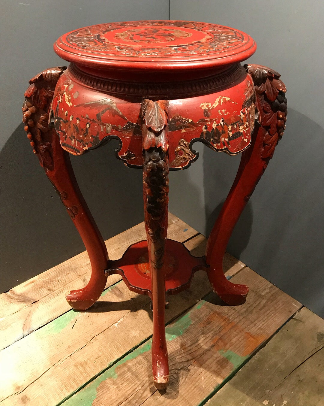 An Oriental red lacquer jardinière stand