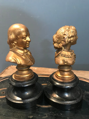 A pair of gilt spelter Gentleman and Lady busts on ebonised bases