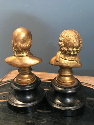 A pair of gilt spelter Gentleman and Lady busts on ebonised bases