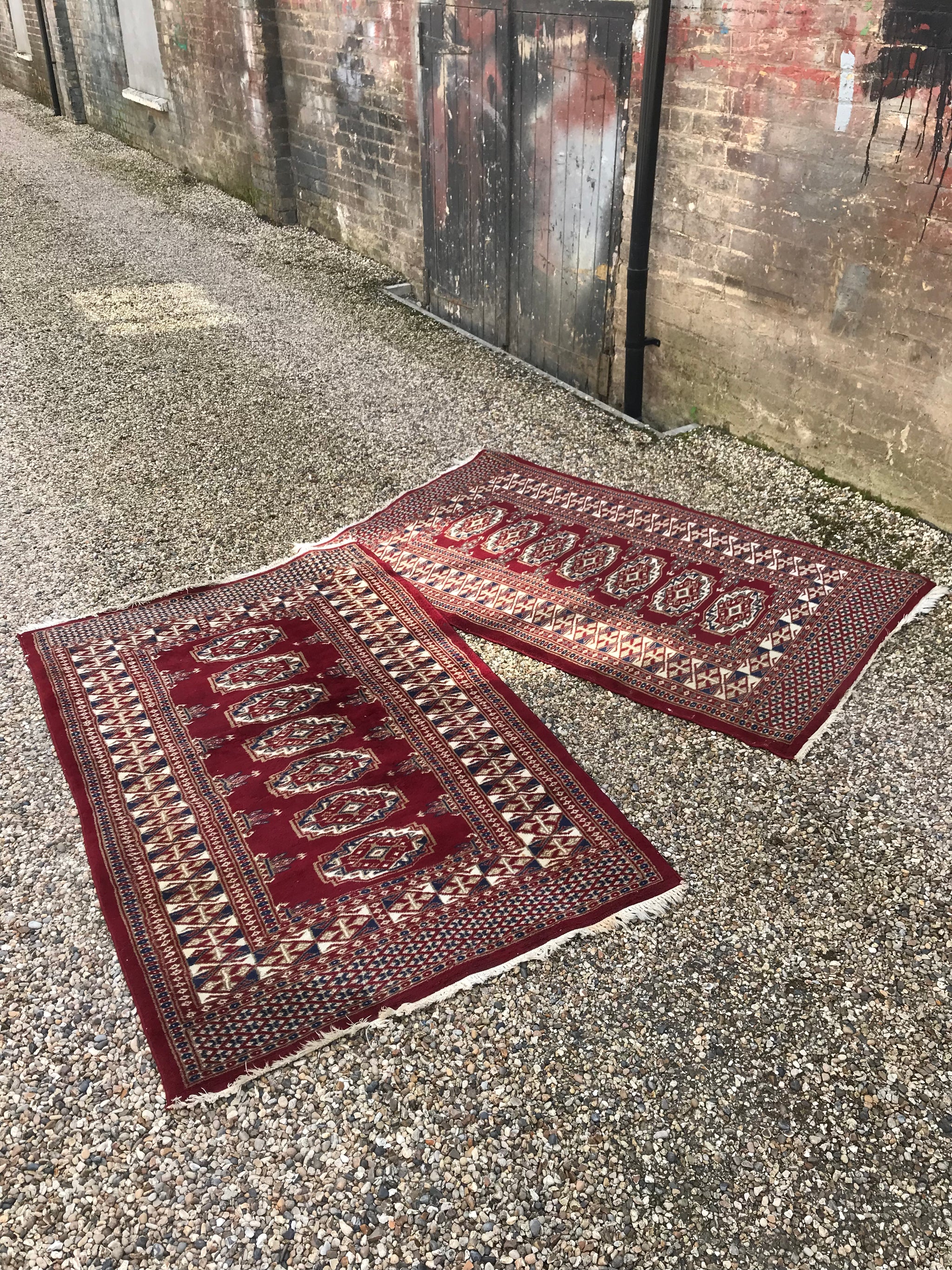 A pair of hand knotted red wool Persian rectangular carpet rugs