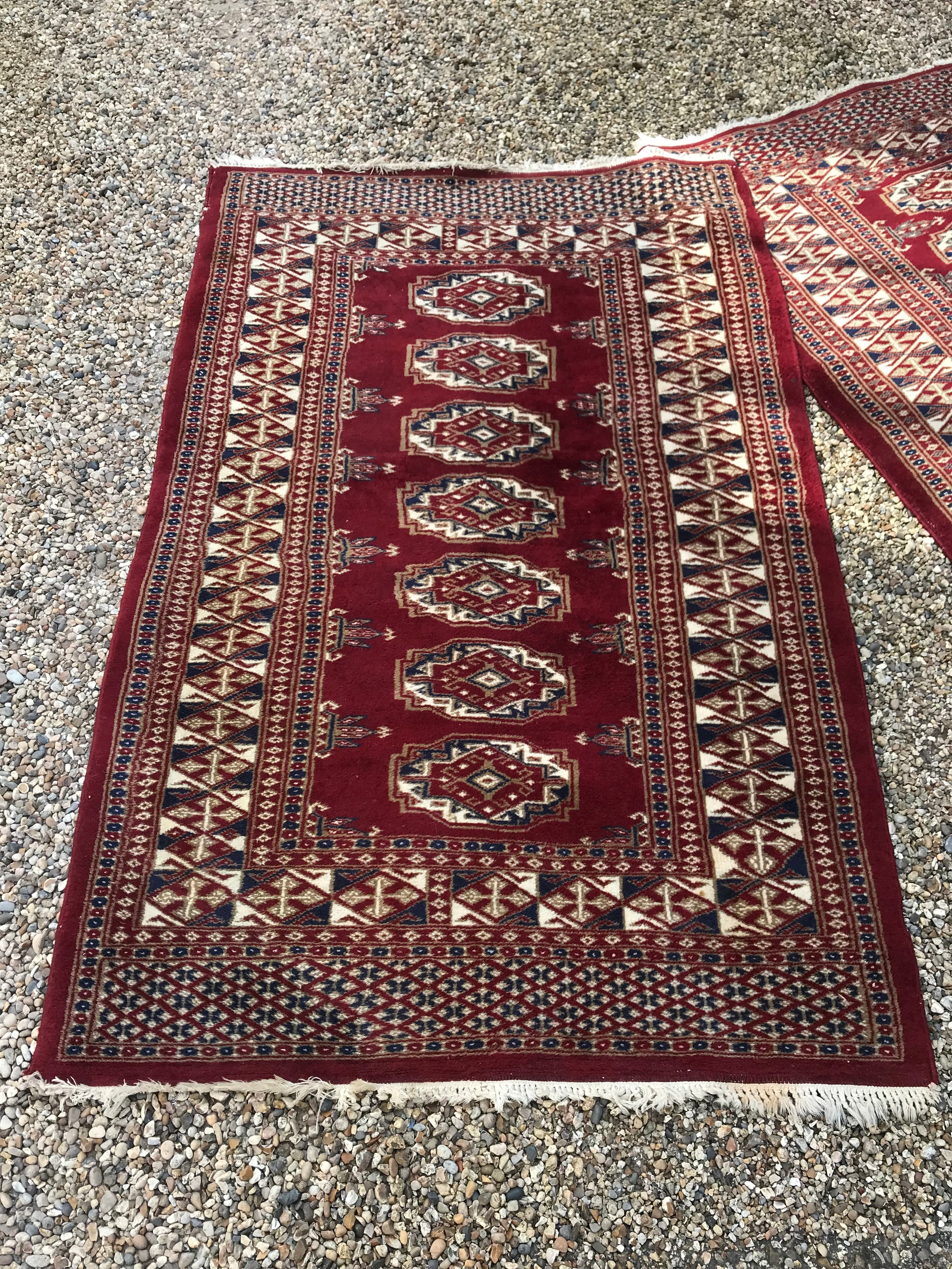 A pair of hand knotted red wool Persian rectangular carpet rugs
