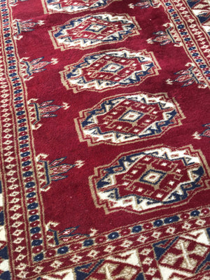 A pair of hand knotted red wool Persian rectangular carpet rugs
