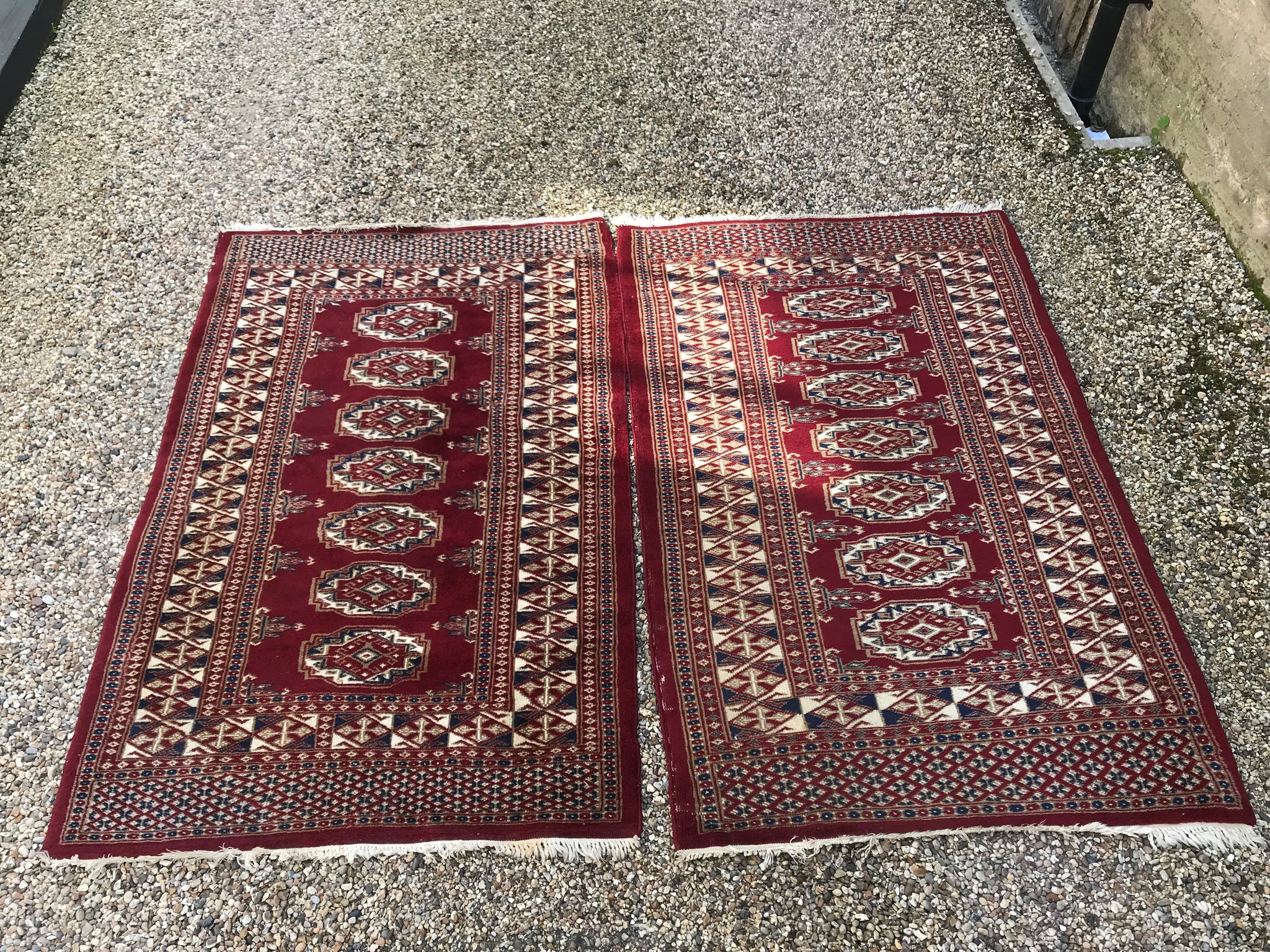 A pair of hand knotted red wool Persian rectangular carpet rugs
