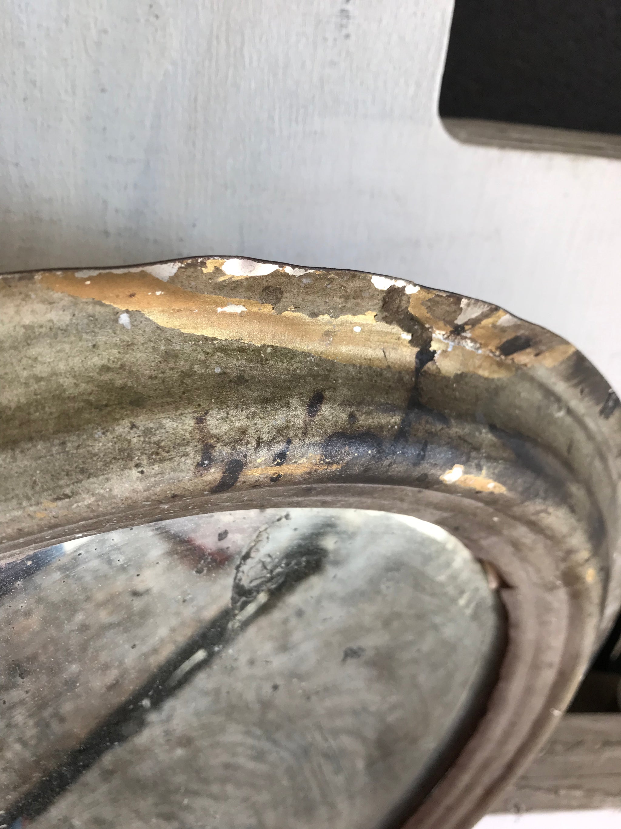 A distressed oval gilt wall mirror