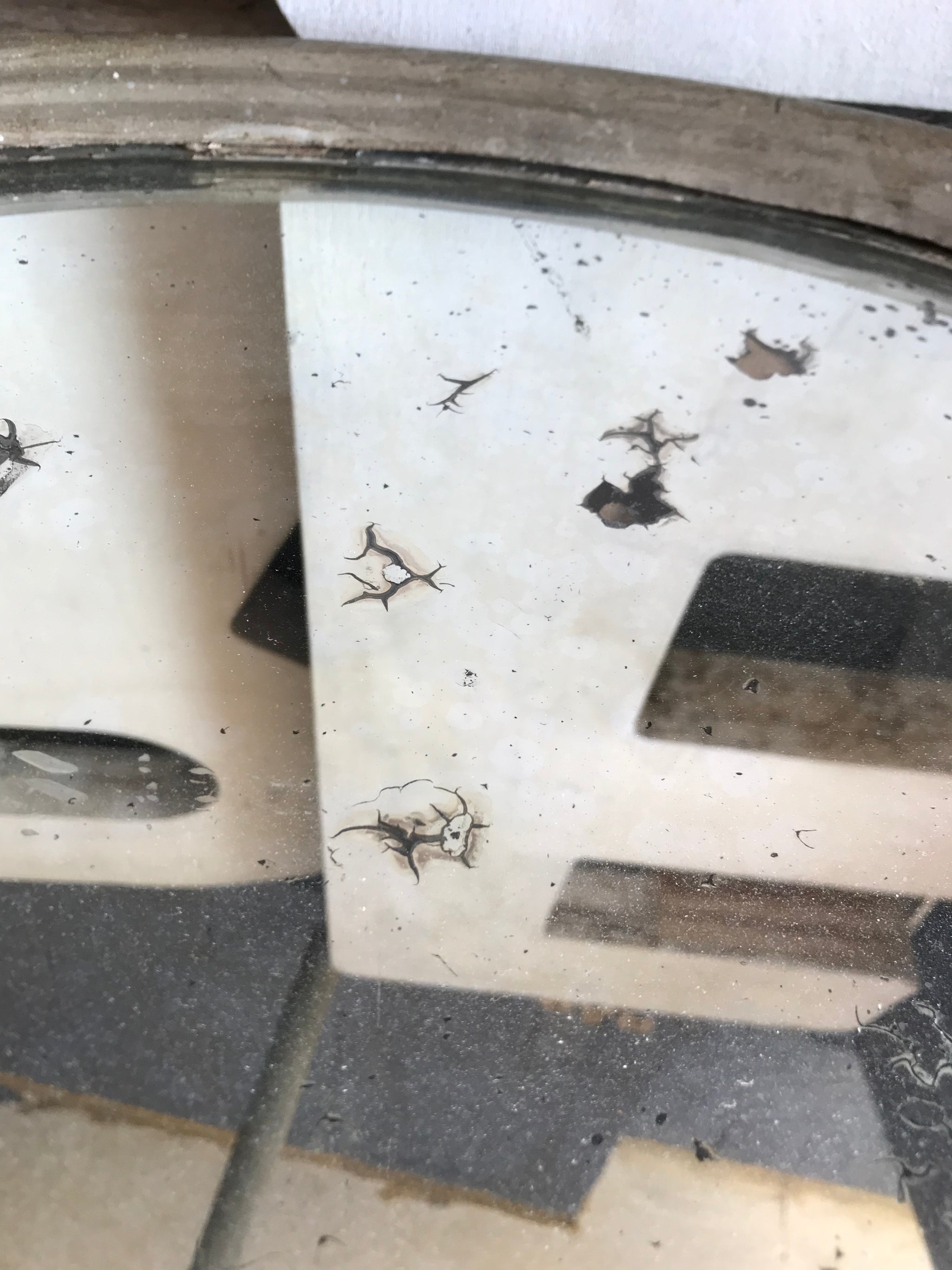 A distressed oval gilt wall mirror