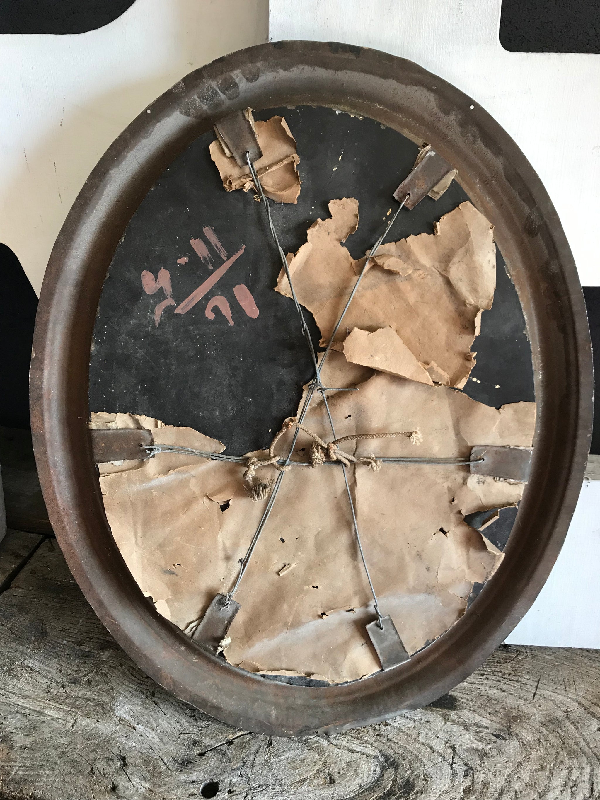 A distressed oval gilt wall mirror
