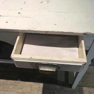 A slim white console table with single drawer