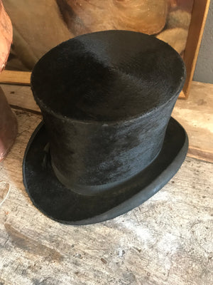 A Victorian silk black top hat and leather hatbox with key