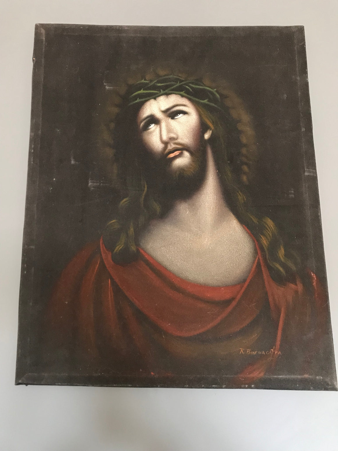A signed religious oil painting of Jesus Christ on black velvet