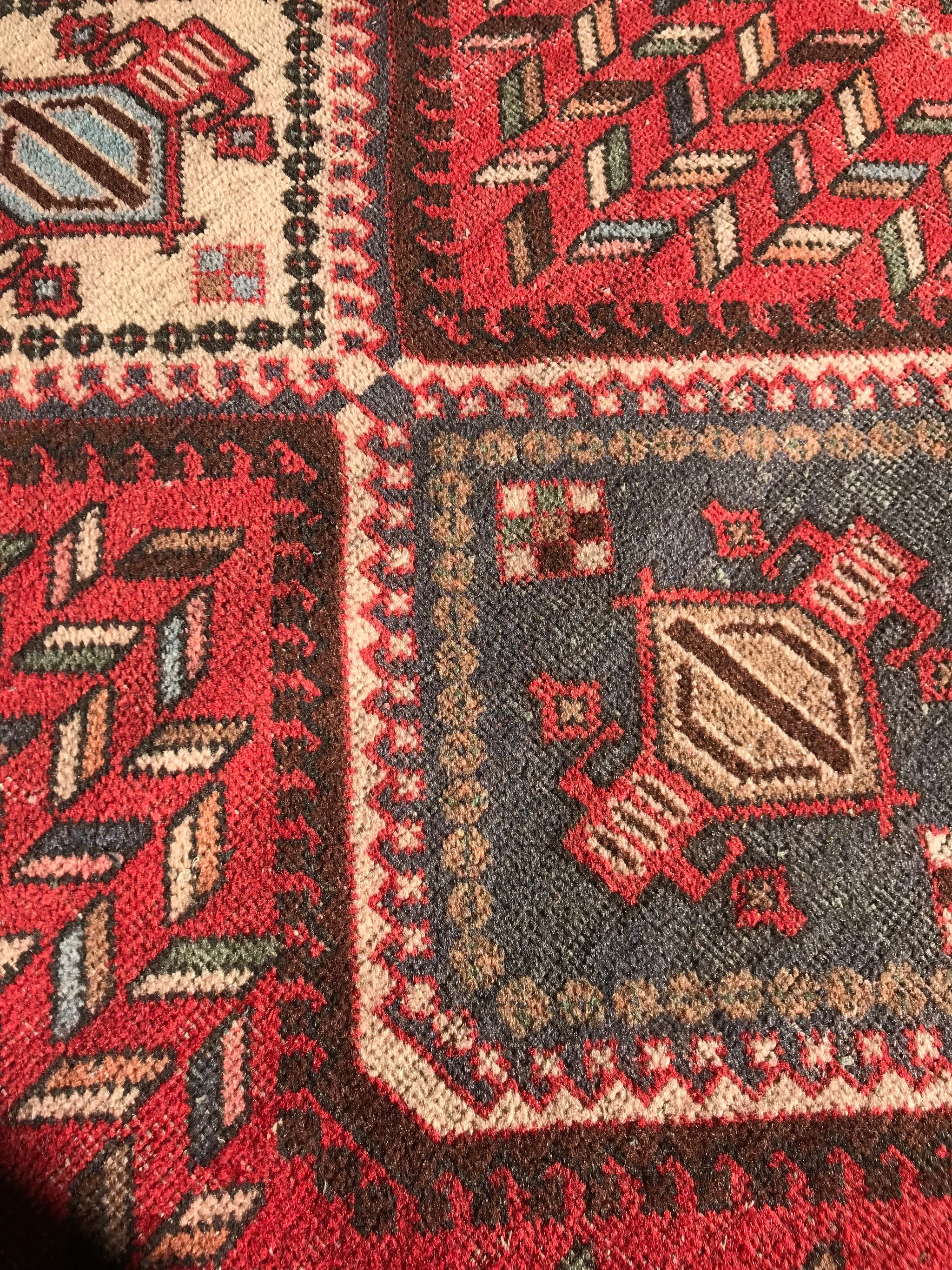 A thick heavyweight rectangular red ground wool Persian rug