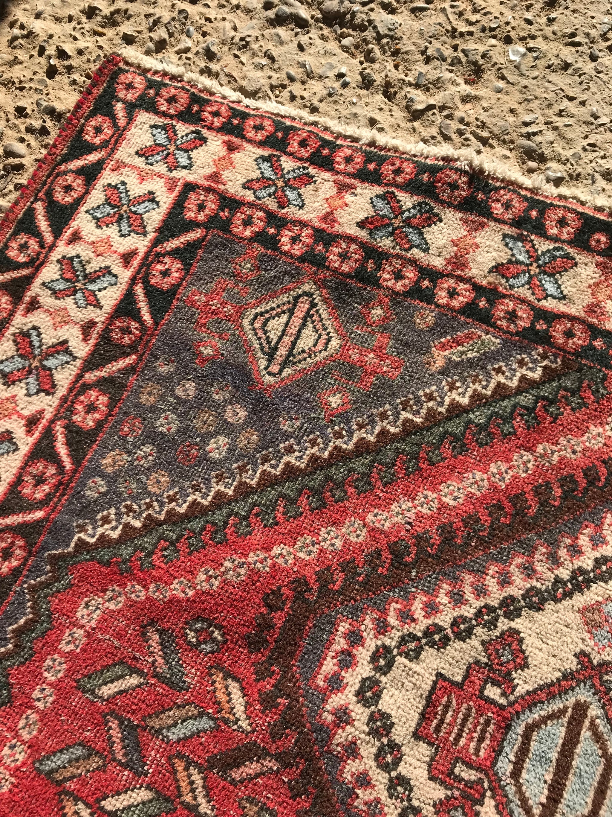 A thick heavyweight rectangular red ground wool Persian rug