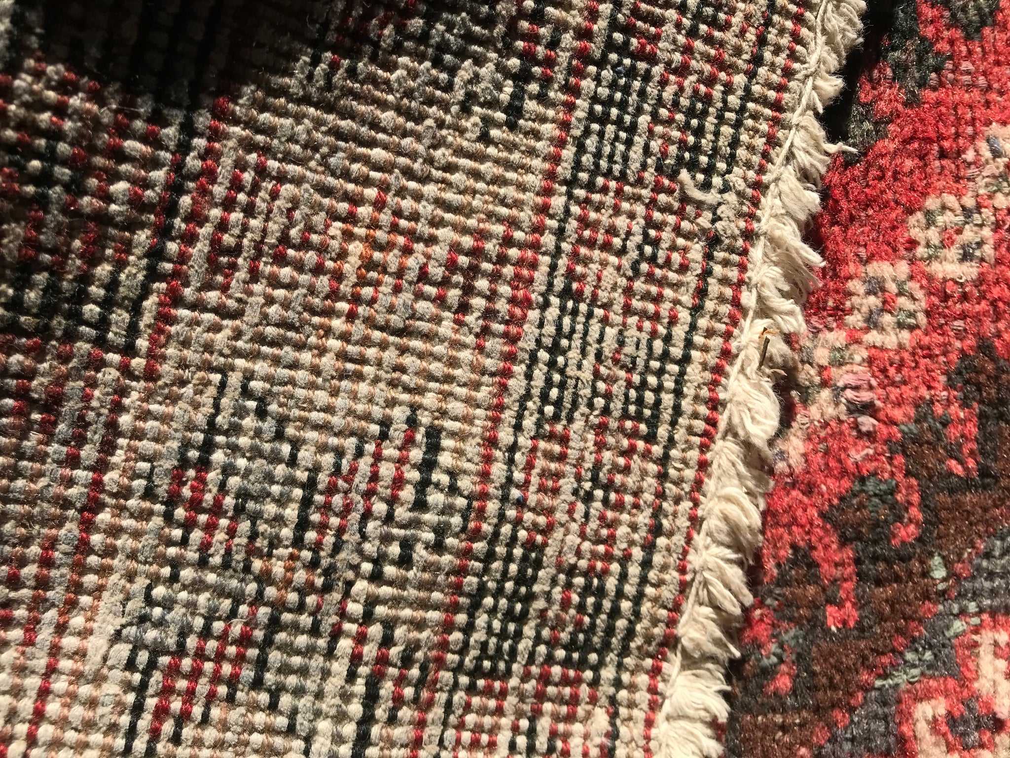 A thick heavyweight rectangular red ground wool Persian rug