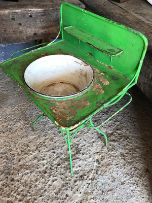 A shabby chic green metal wash stand with enamel basin