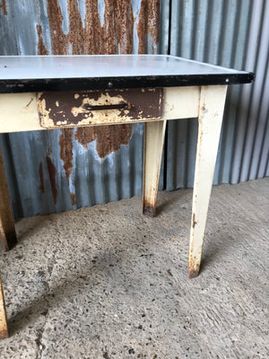 A rustic metal table with enamel top