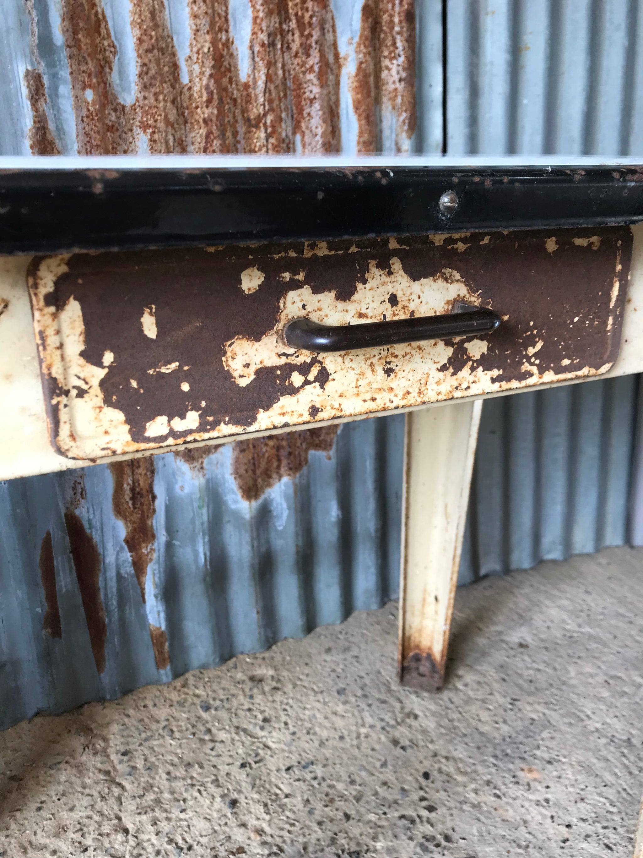 A rustic metal table with enamel top