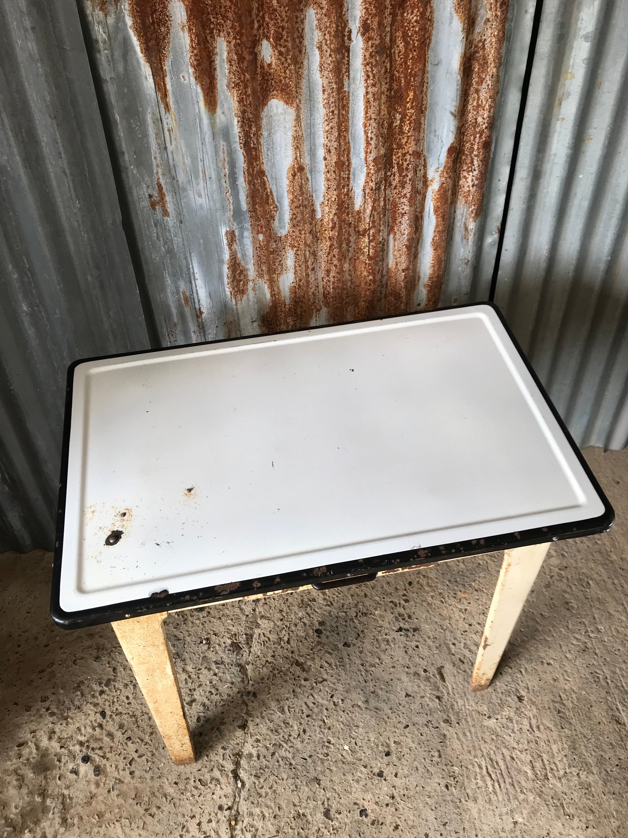 A rustic metal table with enamel top Belle and Beast Emporium