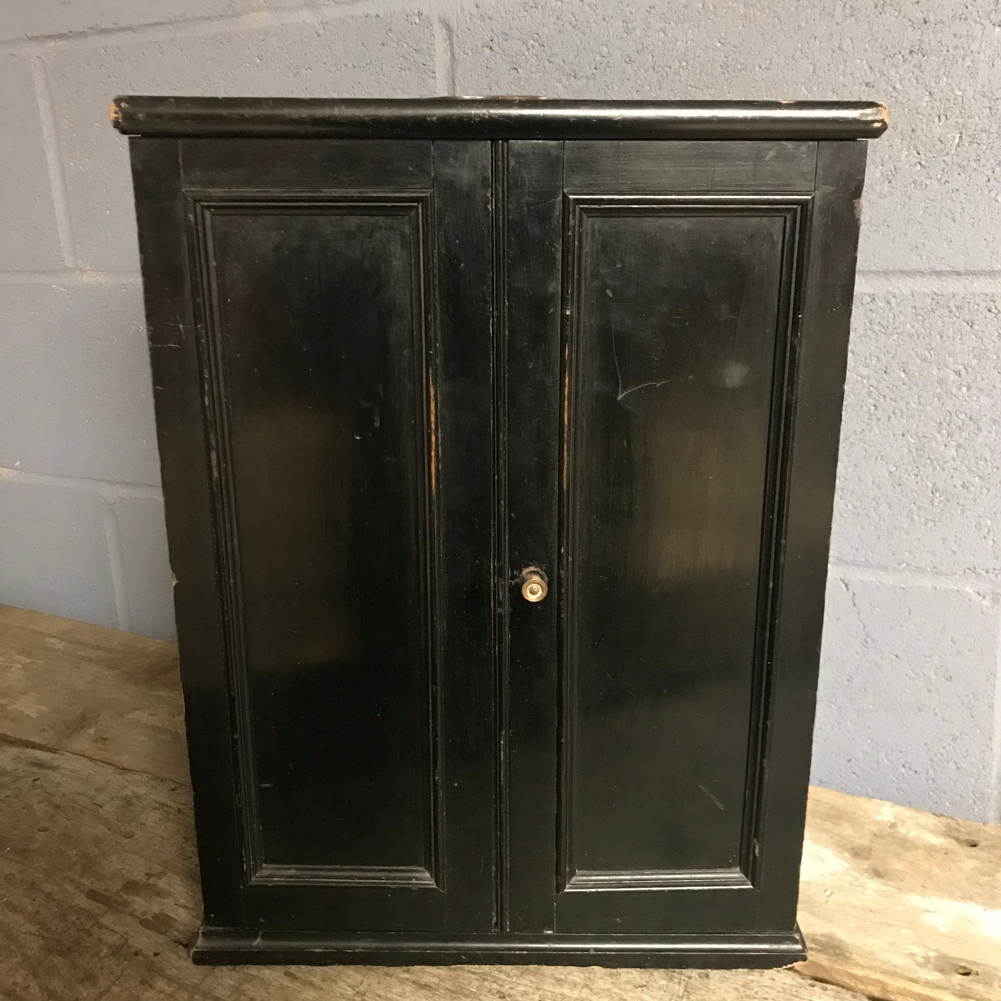 A black ebonised trophy display cabinet with red velvet inlay