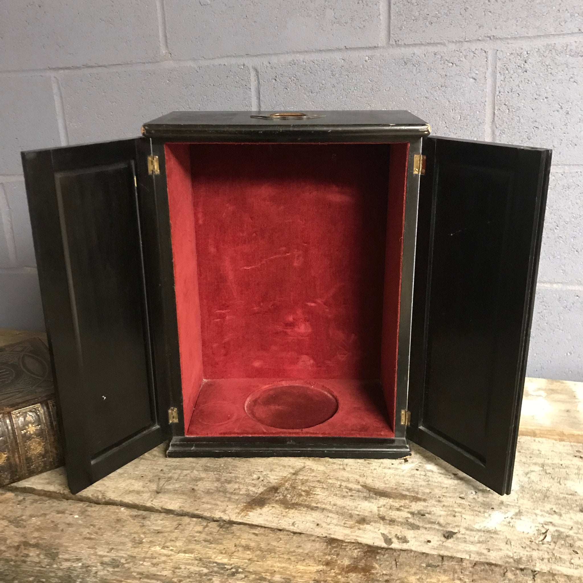 A black ebonised trophy display cabinet with red velvet inlay
