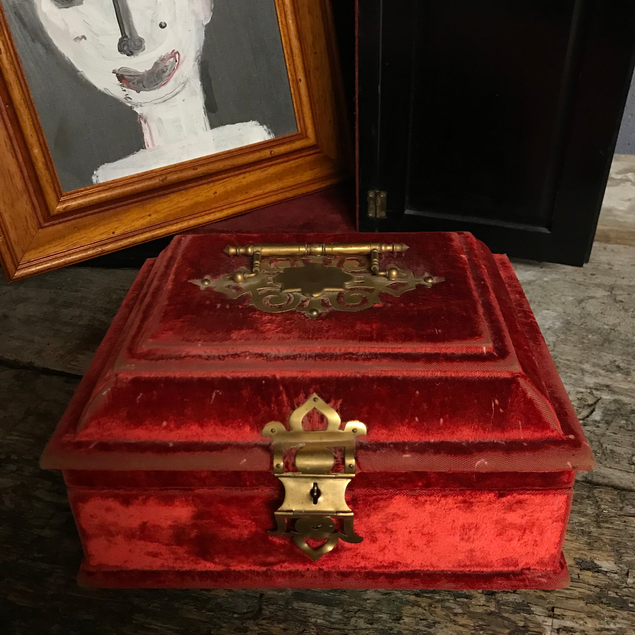 An ornate red velvet and brass vanity case