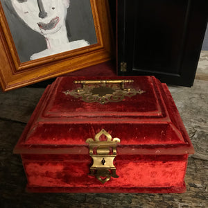 An ornate red velvet and brass vanity case