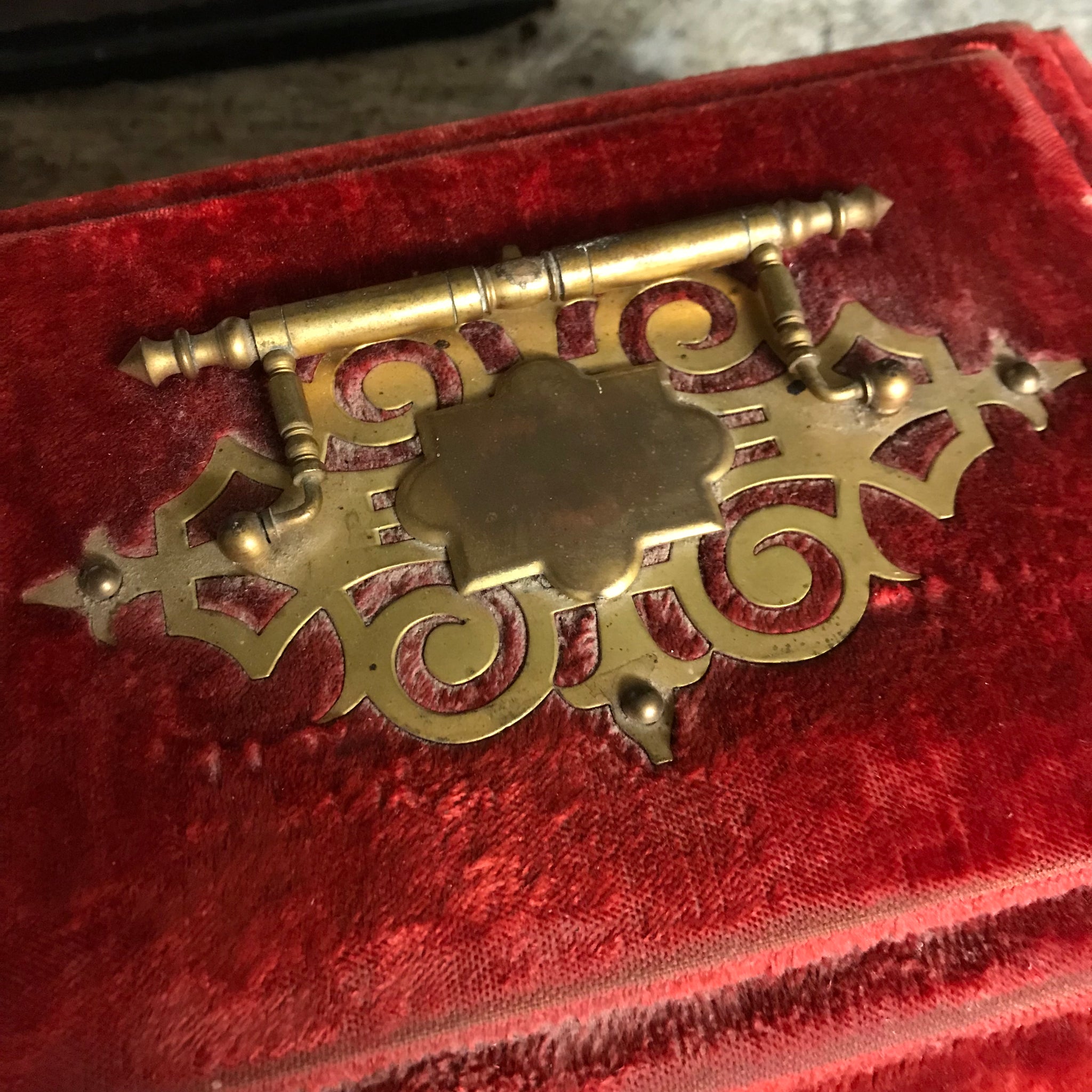 An ornate red velvet and brass vanity case