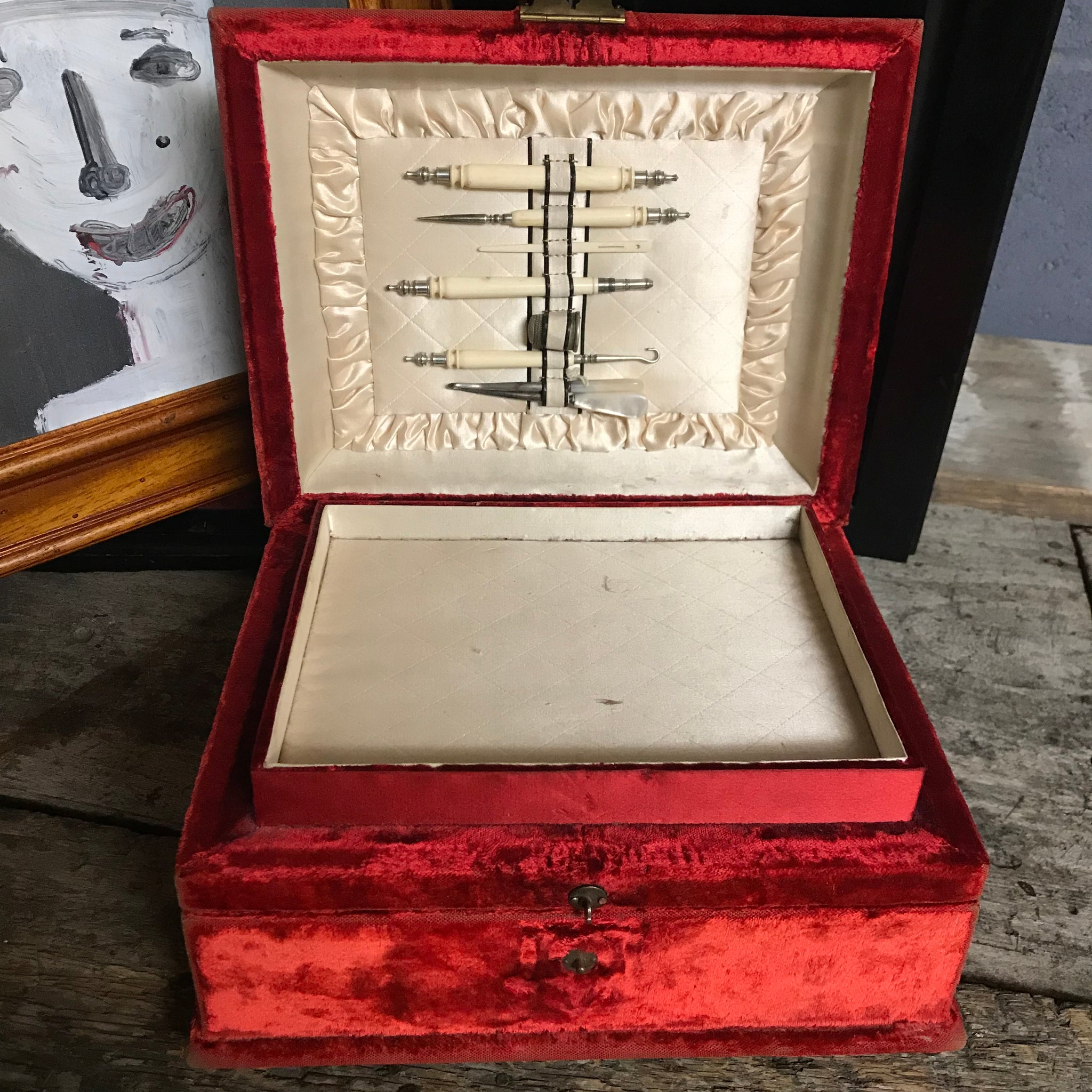 An ornate red velvet and brass vanity case