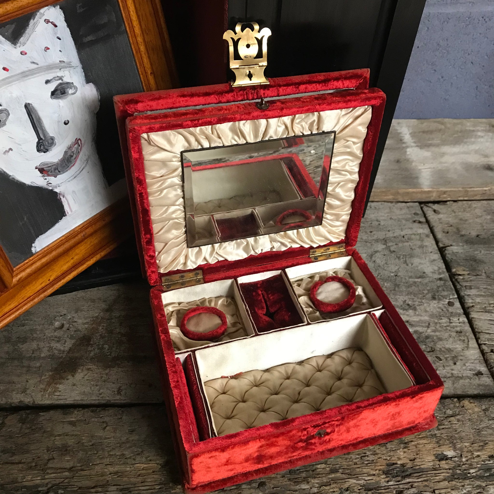 An ornate red velvet and brass vanity case