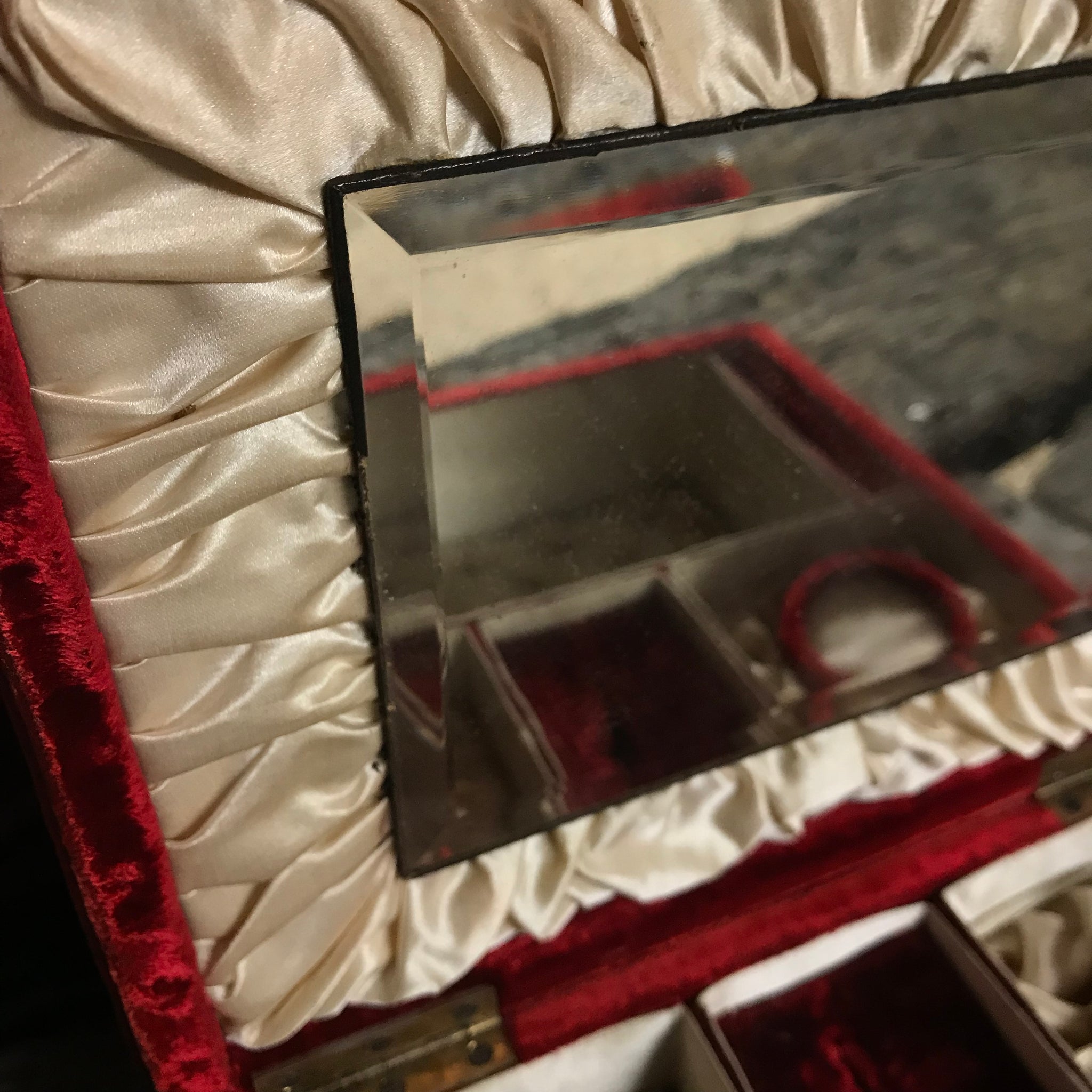 An ornate red velvet and brass vanity case