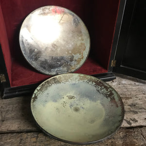 A pair of distressed parabolic mirrors