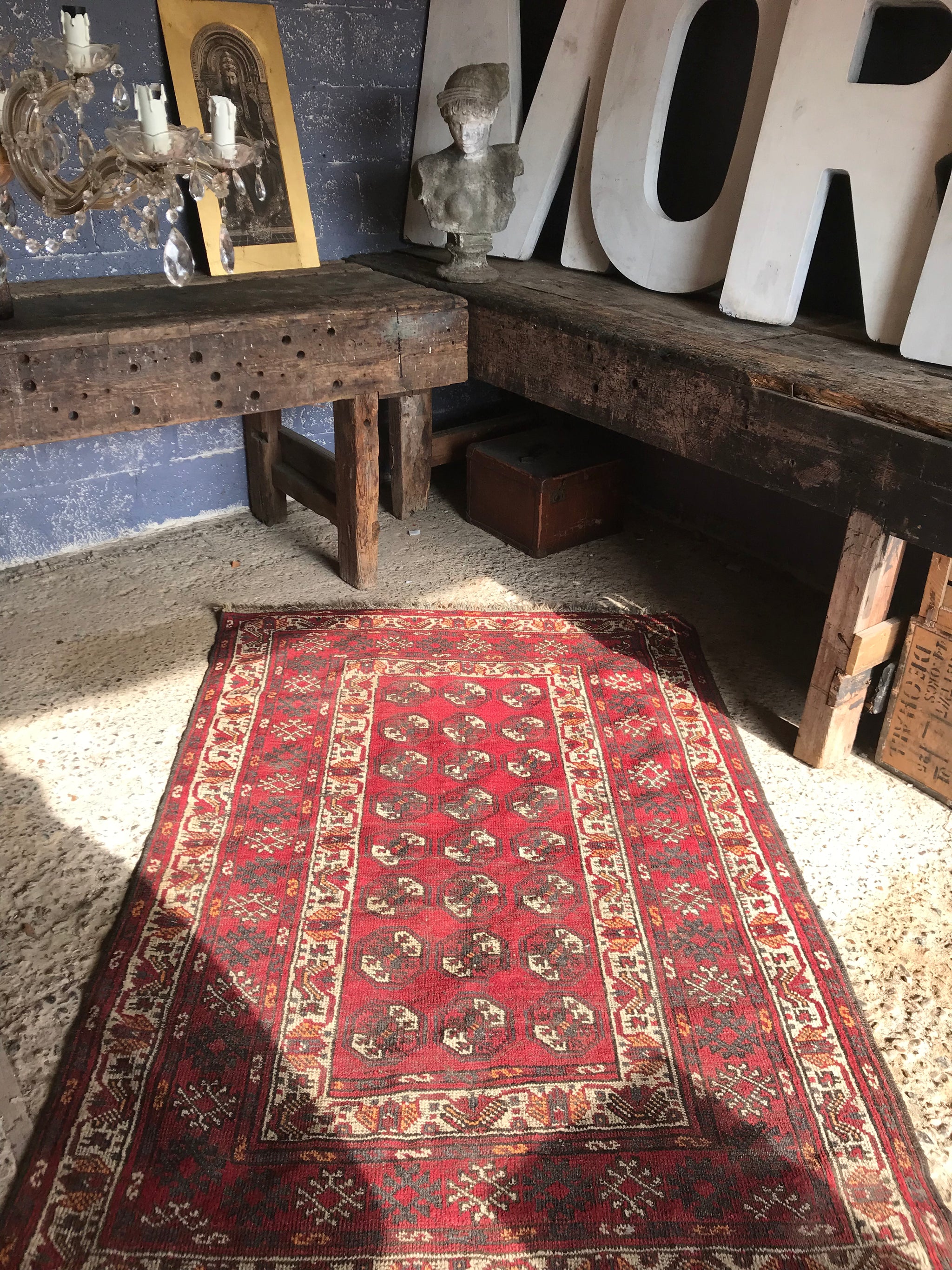 A Persian red ground lozenge rectangular rug