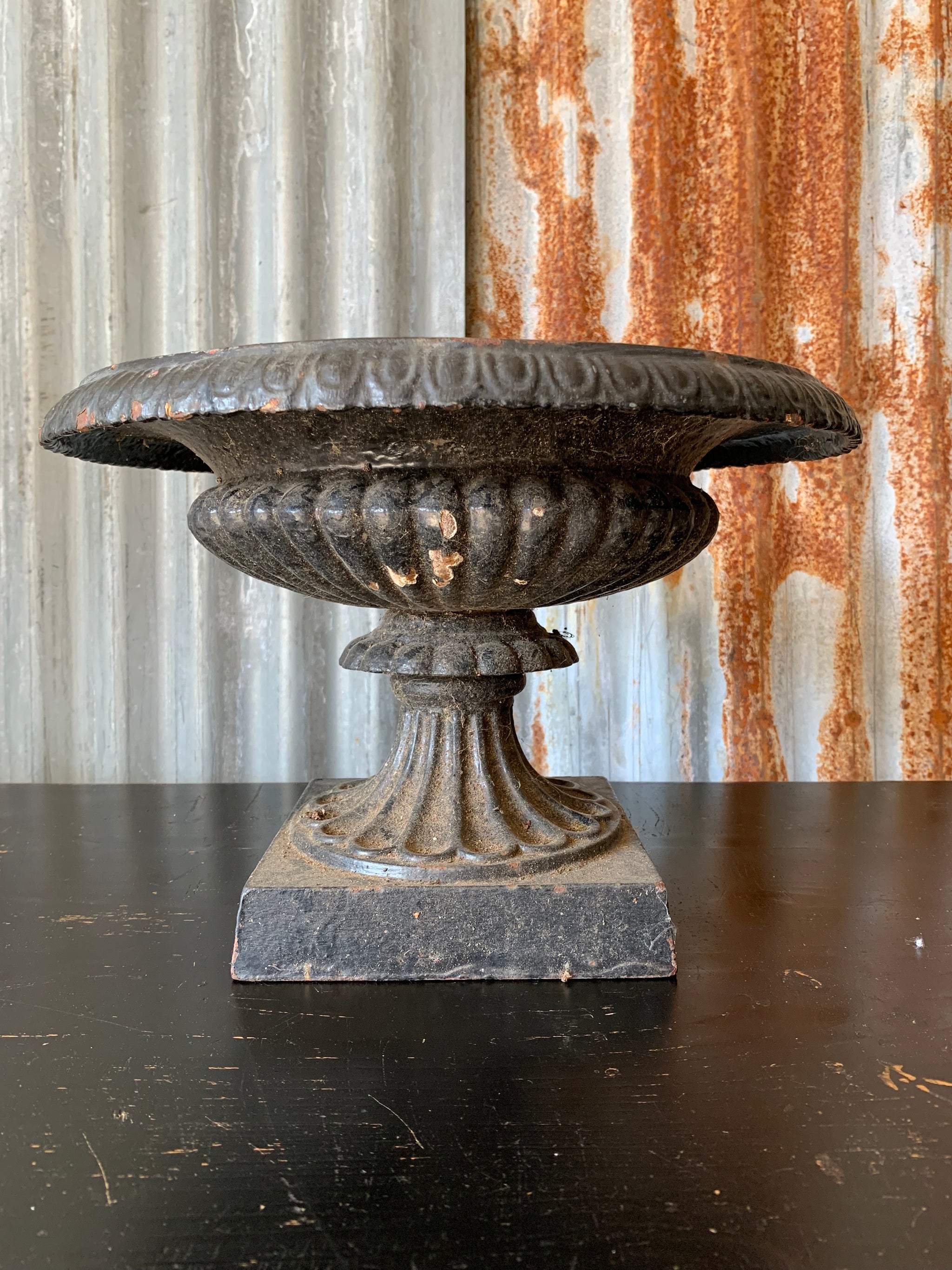 A cast iron black tazza urn