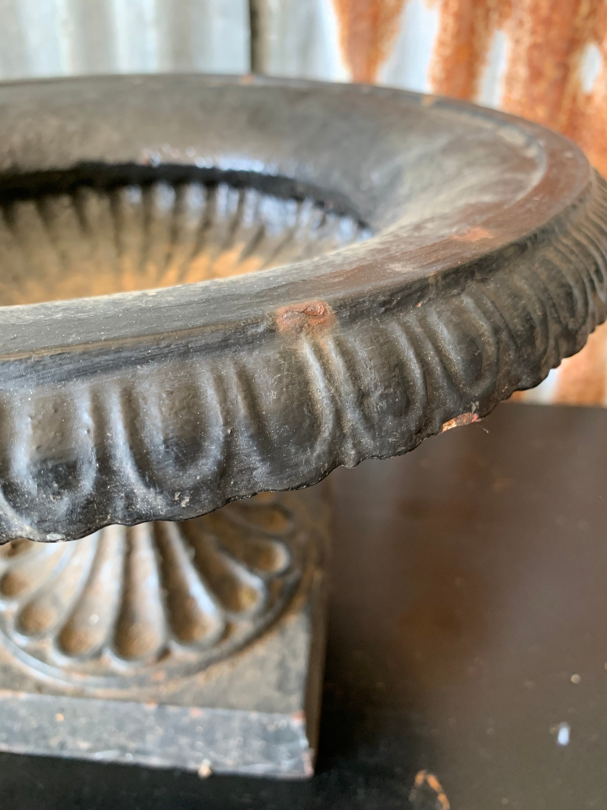 A cast iron black tazza urn