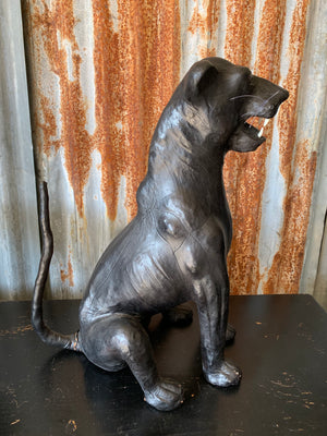A large mid century black leather panther