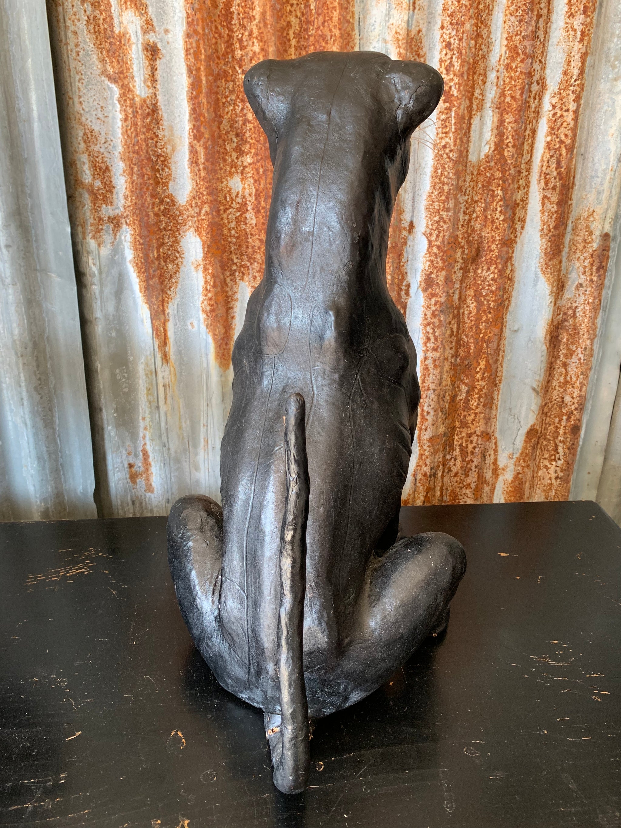 A large mid century black leather panther