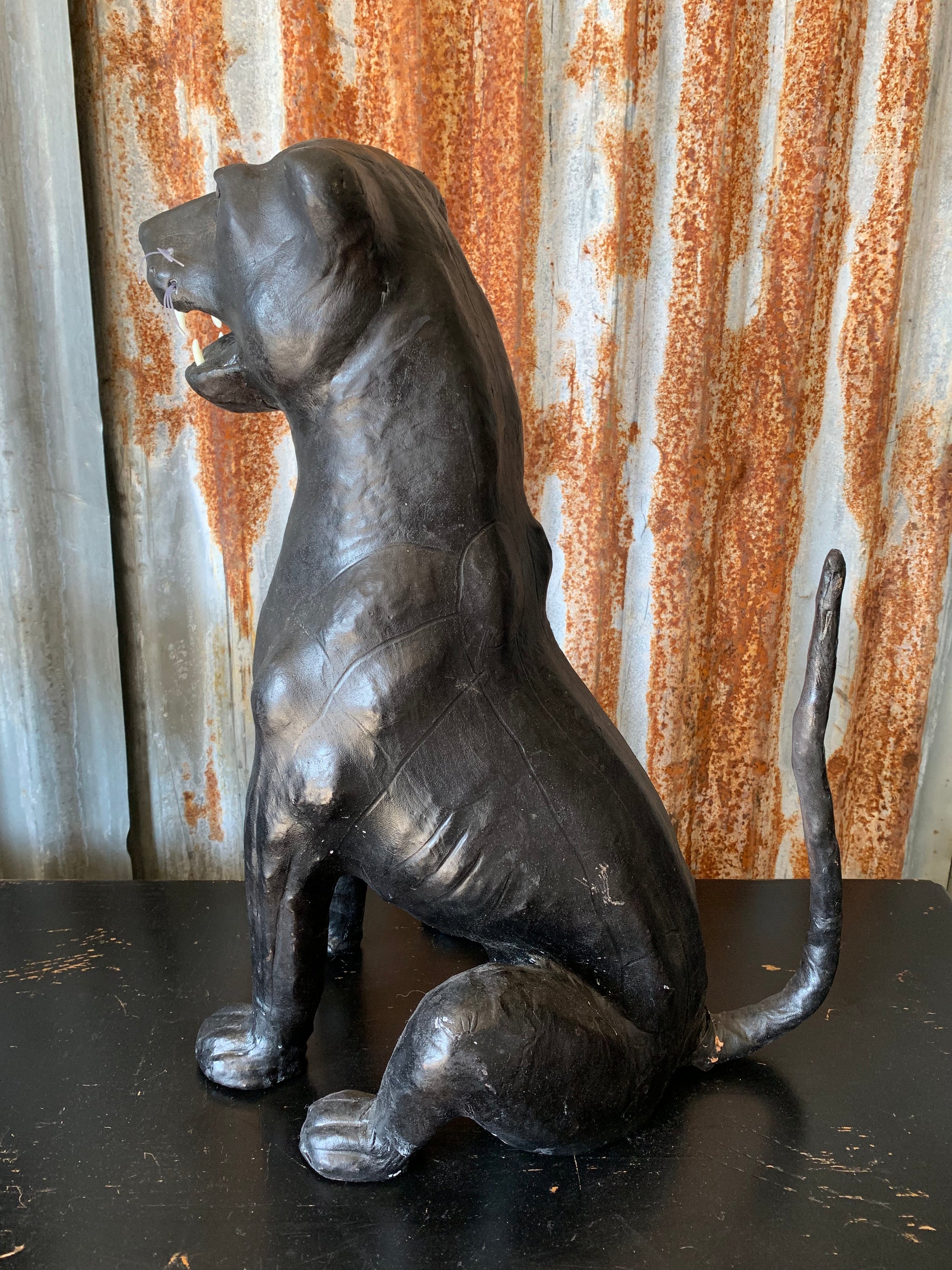 A large mid century black leather panther