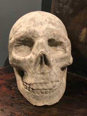 A life size stone Memento Mori skull statue