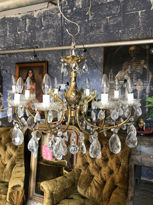 A large 8 arm crystal drop and gilt body chandelier