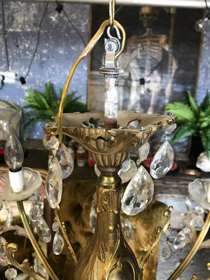 A large 8 arm crystal drop and gilt body chandelier