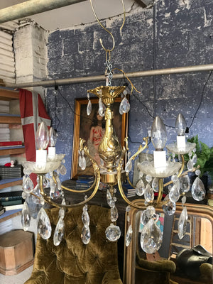A medium 5 arm crystal drop and gilt body chandelier