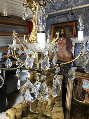 A medium 5 arm crystal drop and gilt body chandelier